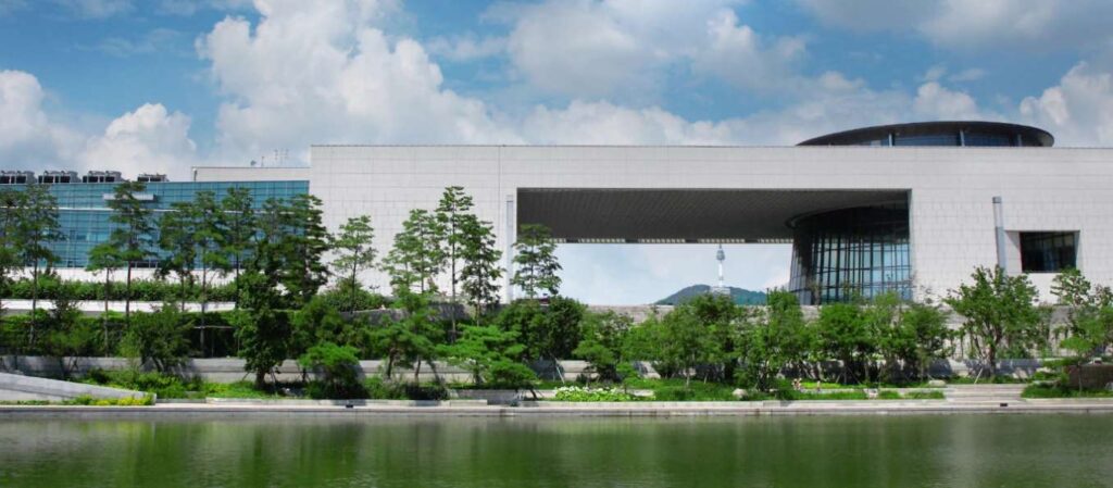Visitors walking toward the main building of the National Museum of Korea in Seoul
