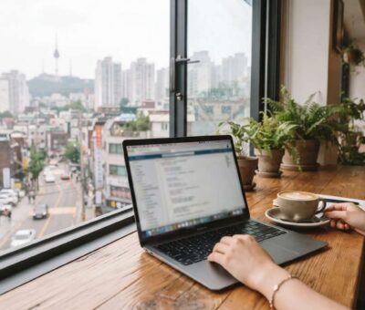 A person working on a laptop in a Seoul cafe